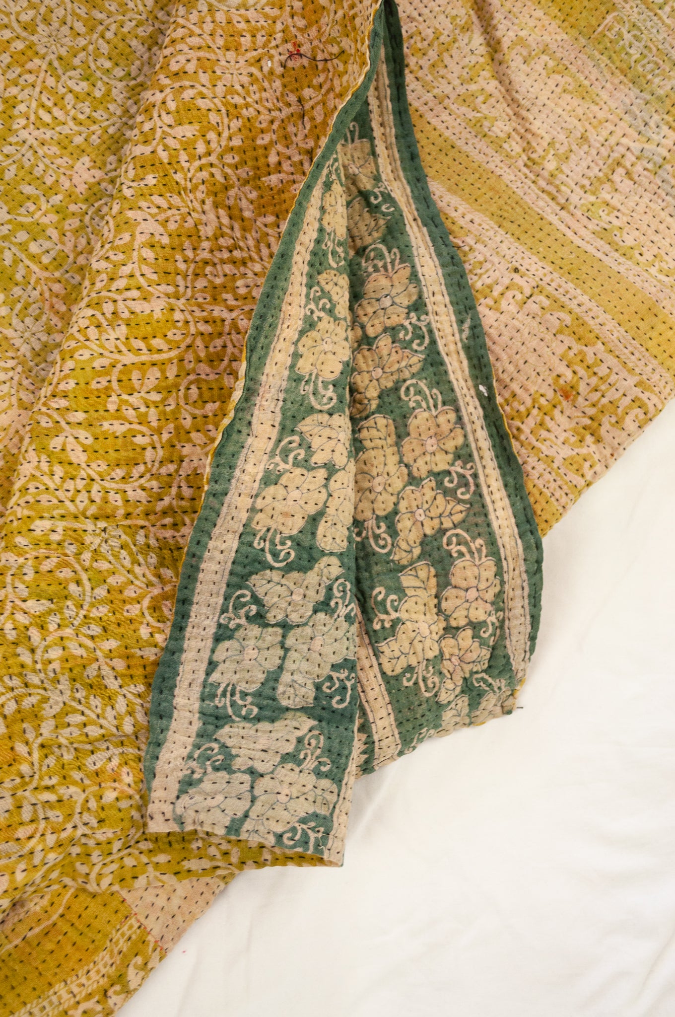 Vintage kantha quilt upcycled from cottonn saris, handstitched, in soft mustard yellow floral with magenta border, green and ecru floral on the reverse.