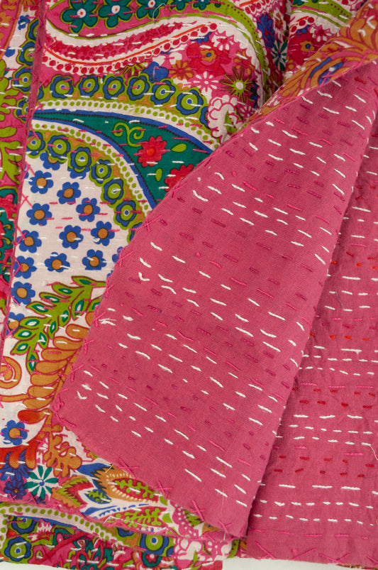 Handstitched cotton kantha quilt, a colourful paisley on a deep pink background, with highlights in lime, emerald, turquoise, white, and tan