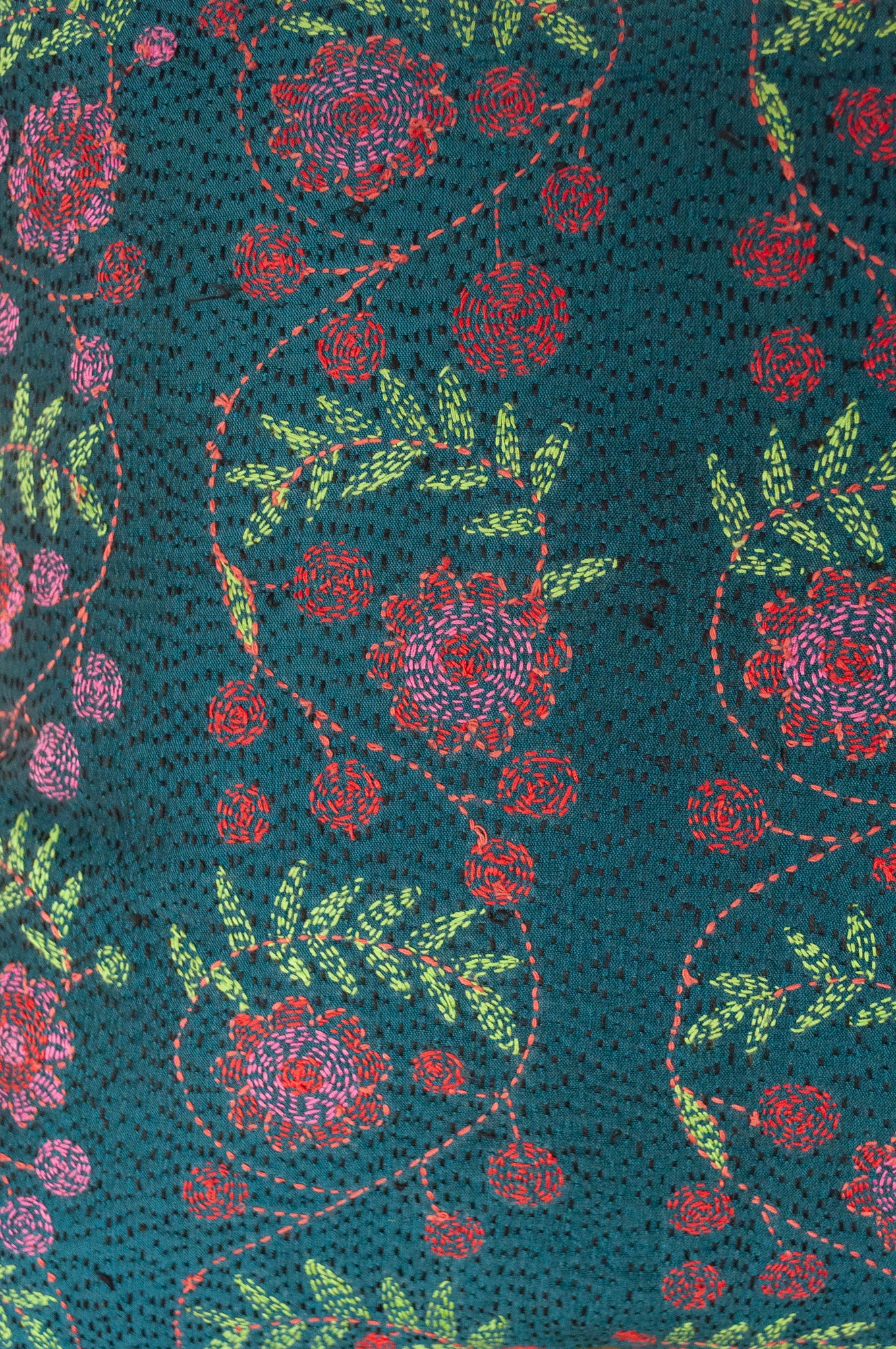 Kantha stitched on vintage silk, this square cushion features panels of floral sprays in cherry red and rose pink, with lime green leaves, on a black stitched teal blue background.