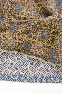 VIntage kantha quilt blockprinted in Bagru print, indigo flowers on olive green background, reverse indigo geometric on off white.