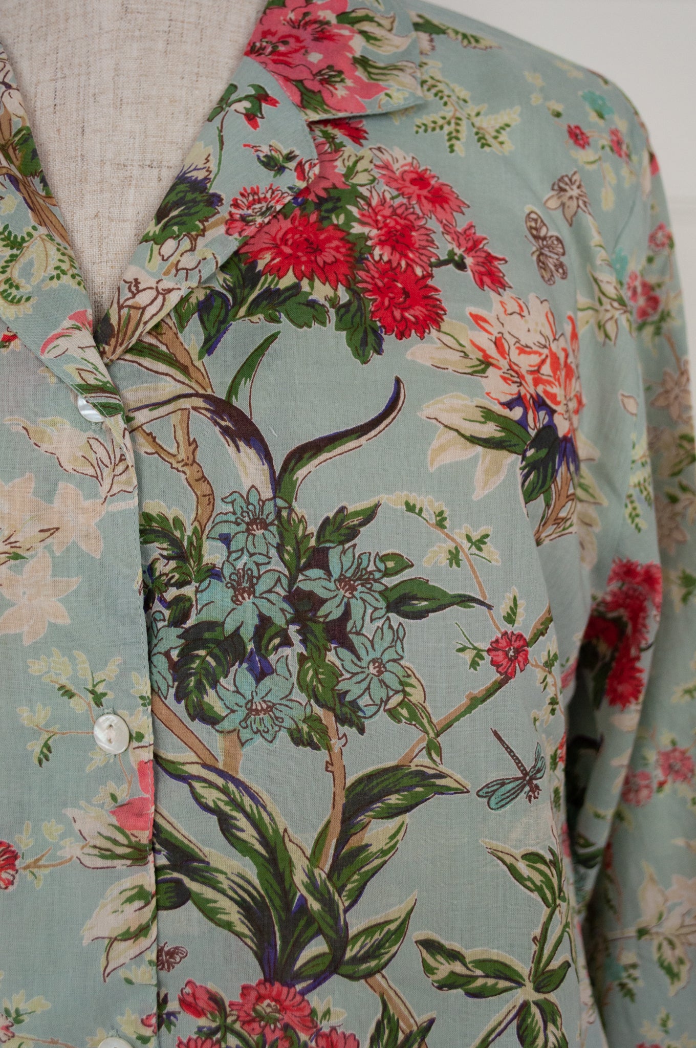 Juniper Hearth cotton voile pyjamas in Country Garden, floral print in rose pink, sage and aqua on soft blue green background.