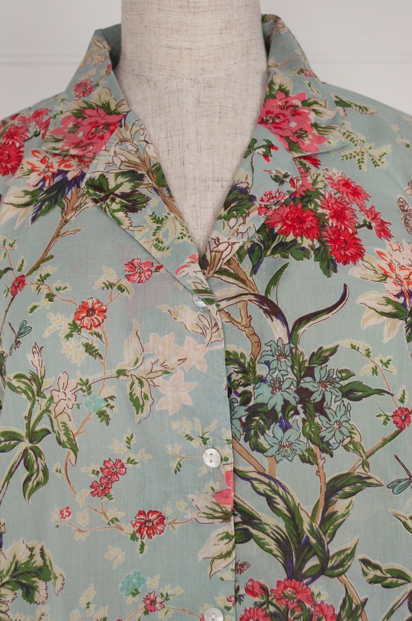 Juniper Hearth cotton voile pyjamas in Country Garden, floral print in rose pink, sage and aqua on soft blue green background.