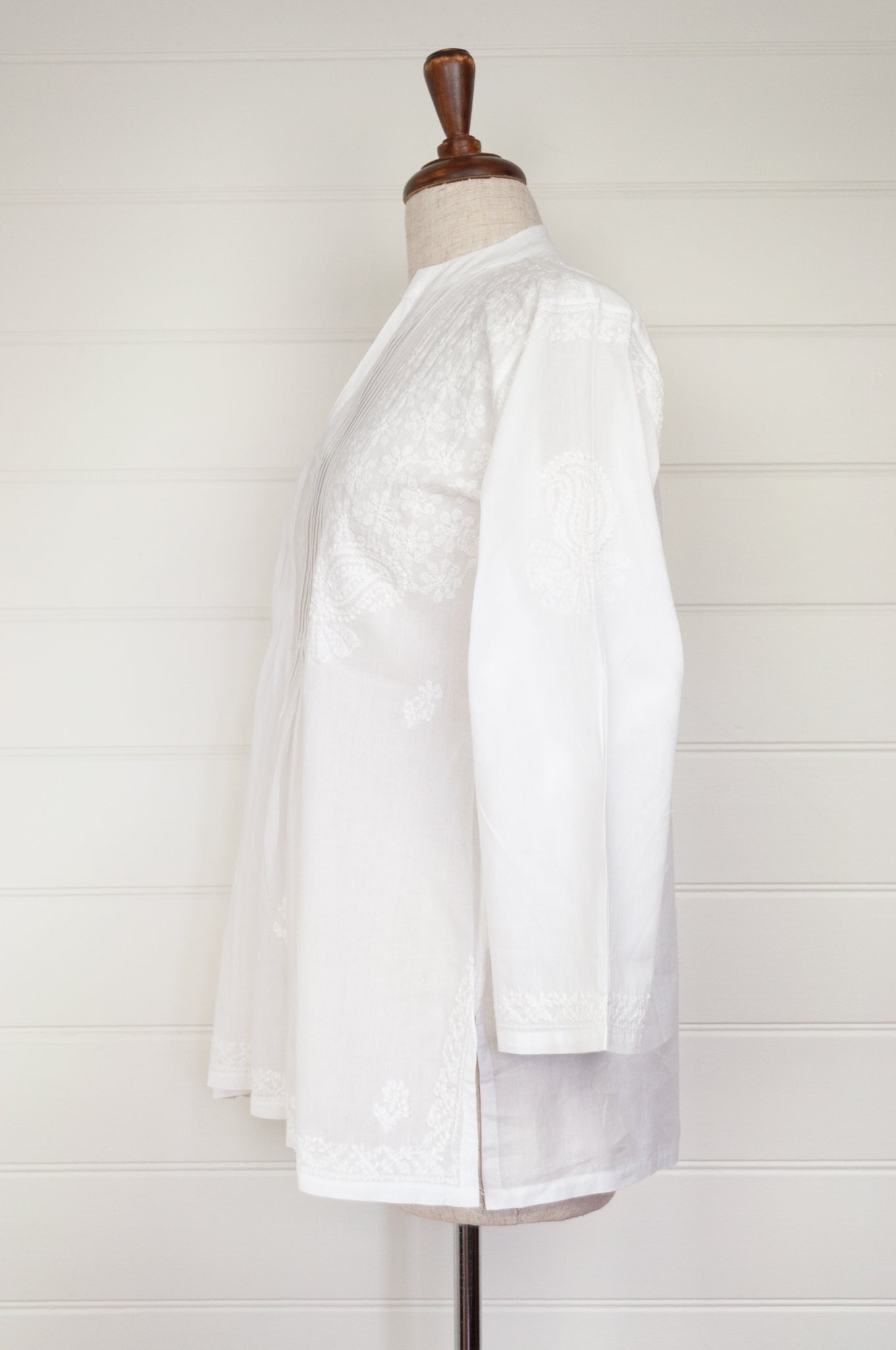 White on white chikankari embroidered pintucked blouse.