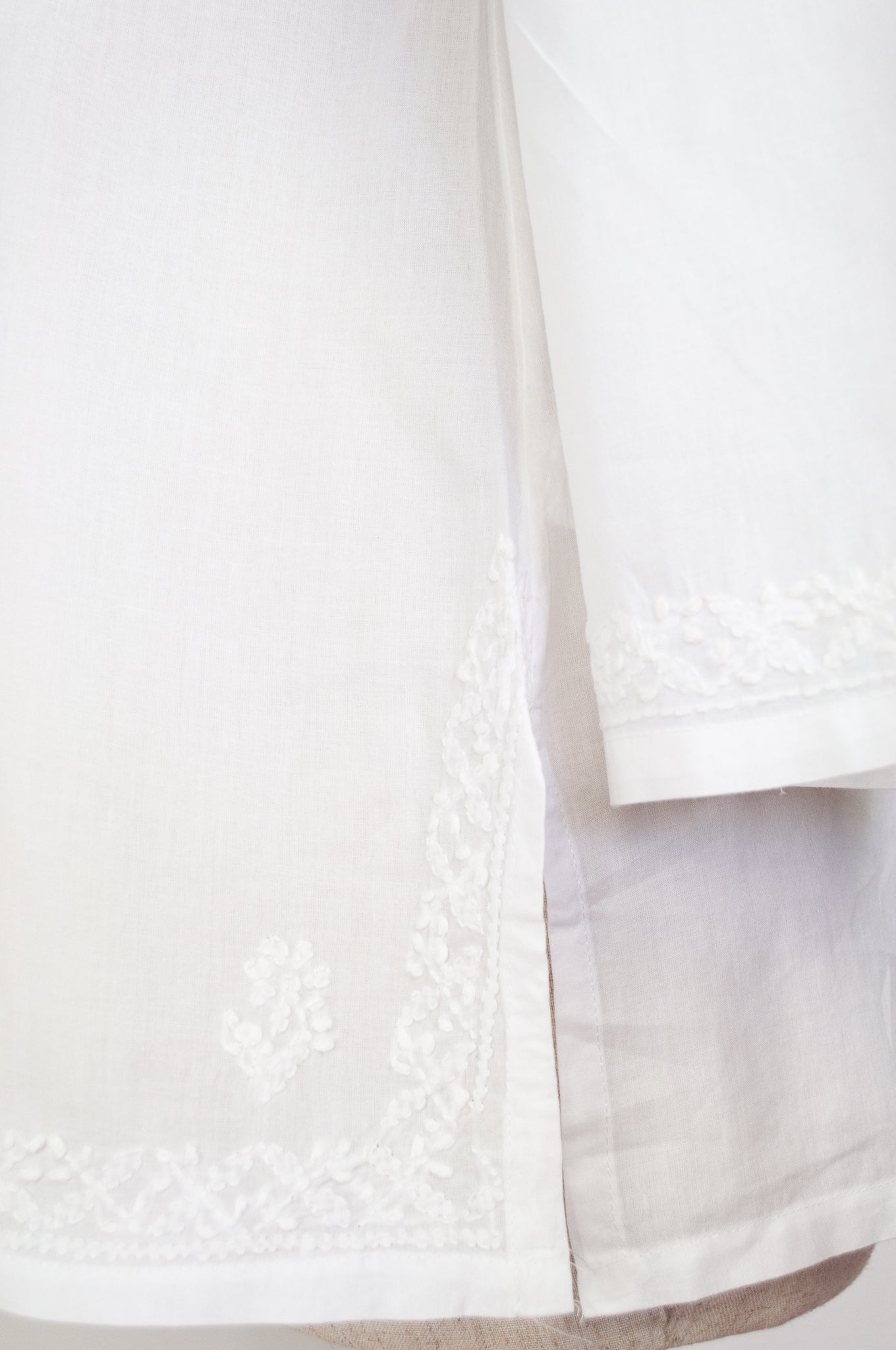 White on white chikankari embroidered pintucked blouse.