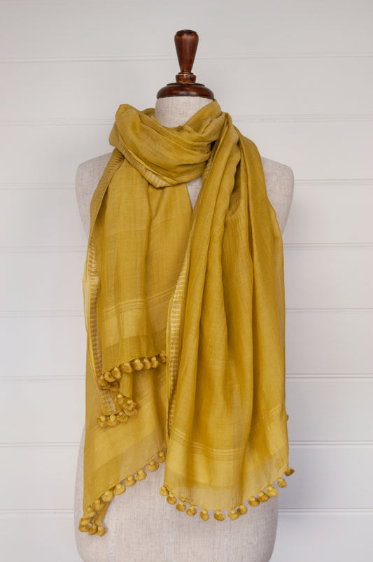 Silk cotton pompom scarf in mustard yellow.