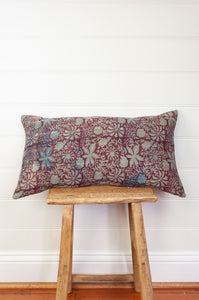 Vintage kantha oblong rectangular bolster cushion blockprinted with floral design in  deep burgundy red with touches of indigo.