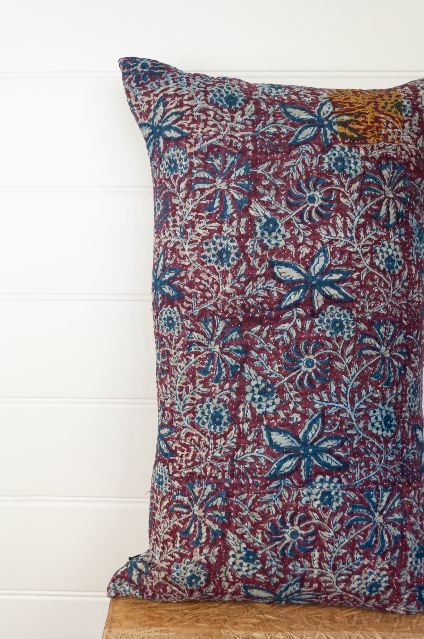 Vintage kantha oblong rectangular bolster cushion blockprinted with floral design in indigo and deep burgundy red.