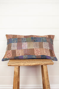 Vintage silk patchwork kantha bolster cushion is in vintage florals in shades of dusky rose, coffee, lavender and denim.