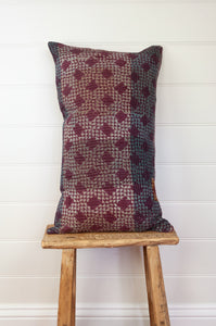 Vintage kantha oblong rectangular bolster cushion blockprinted with check design in deep burgundy red, and stripes of indigo.