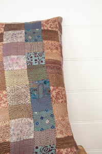 Vintage silk patchwork kantha bolster cushion is in vintage florals in shades of dusky rose, coffee, lavender and denim.