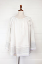 Load image into Gallery viewer, Juniper Hearth Yuka top in fine white cotton with self check, fine black stripe border with lavender highlight, gathered neck, loose fit one size long sleeve smock tunic top.