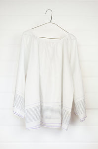 Juniper Hearth Yuka top in fine white cotton with self check, fine black stripe border with lavender highlight, gathered neck, loose fit one size long sleeve smock tunic top.