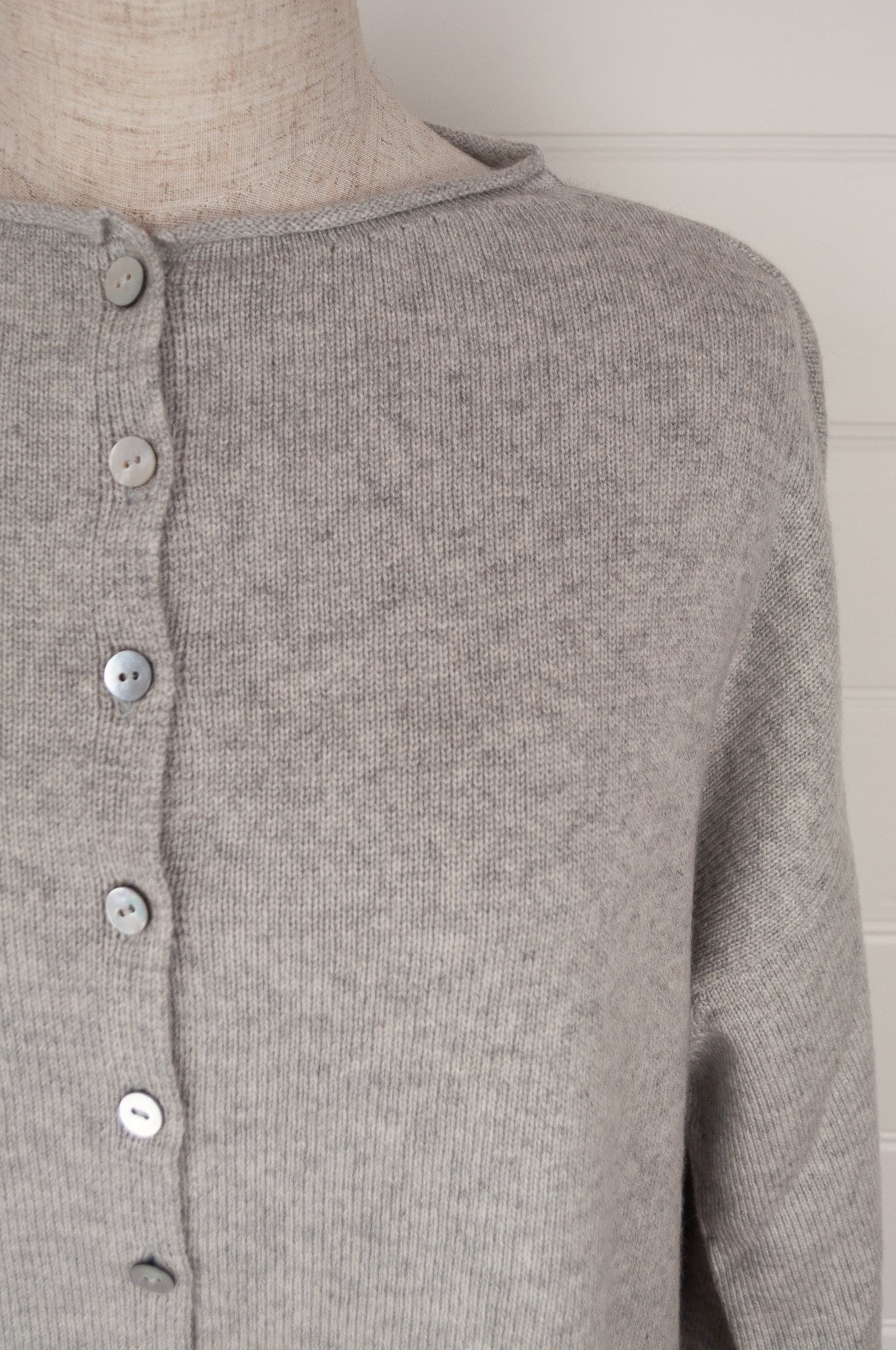 Juniper Hearth ash grey marle reversible one size cashmere cardigan, roll neck edges to neck, sleeves and hem, shell buttons, can be worn as a cardigan or reversed as a sweater.