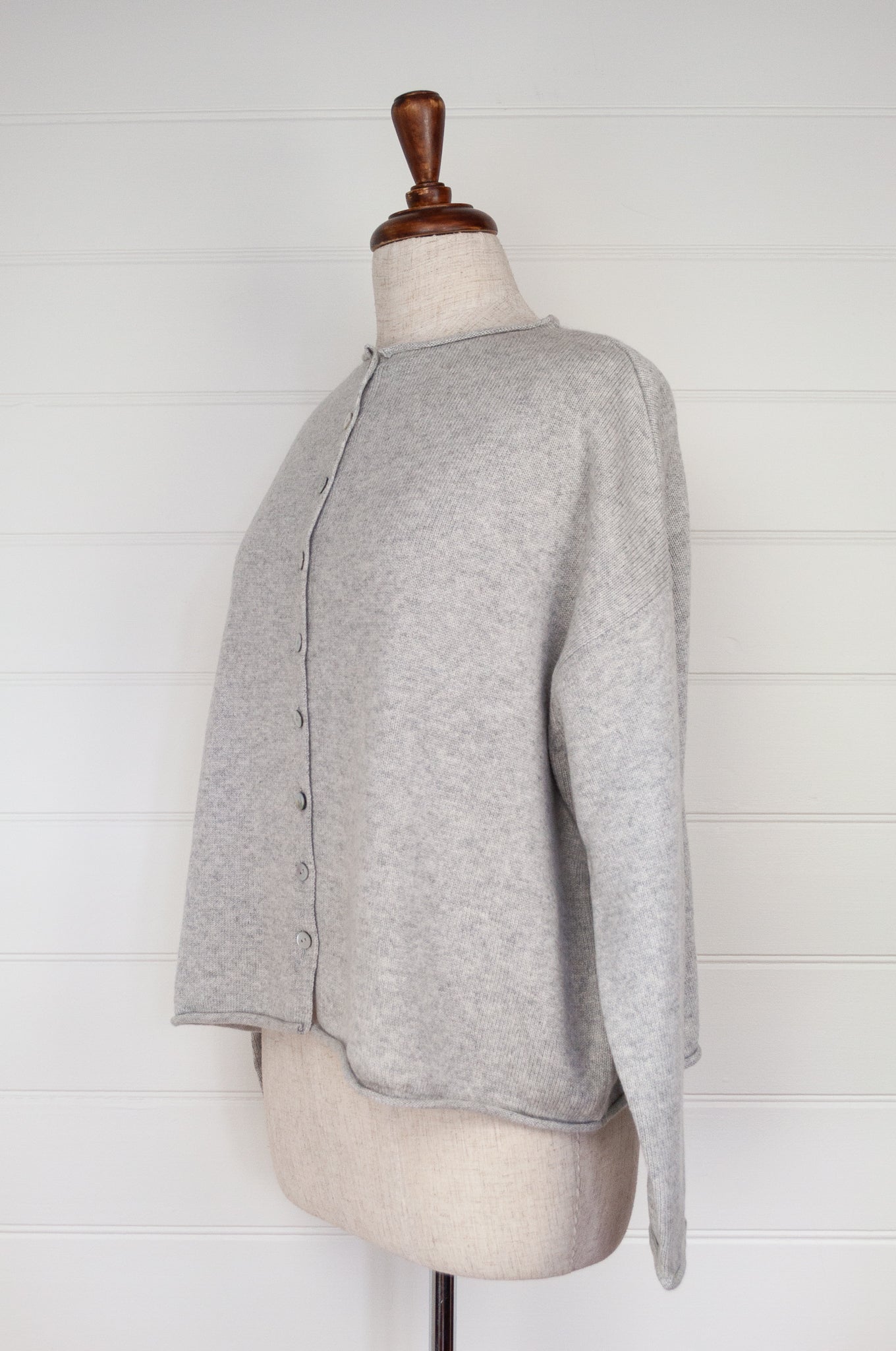 Juniper Hearth ash grey marle reversible one size cashmere cardigan, roll neck edges to neck, sleeves and hem, shell buttons, can be worn as a cardigan or reversed as a sweater.
