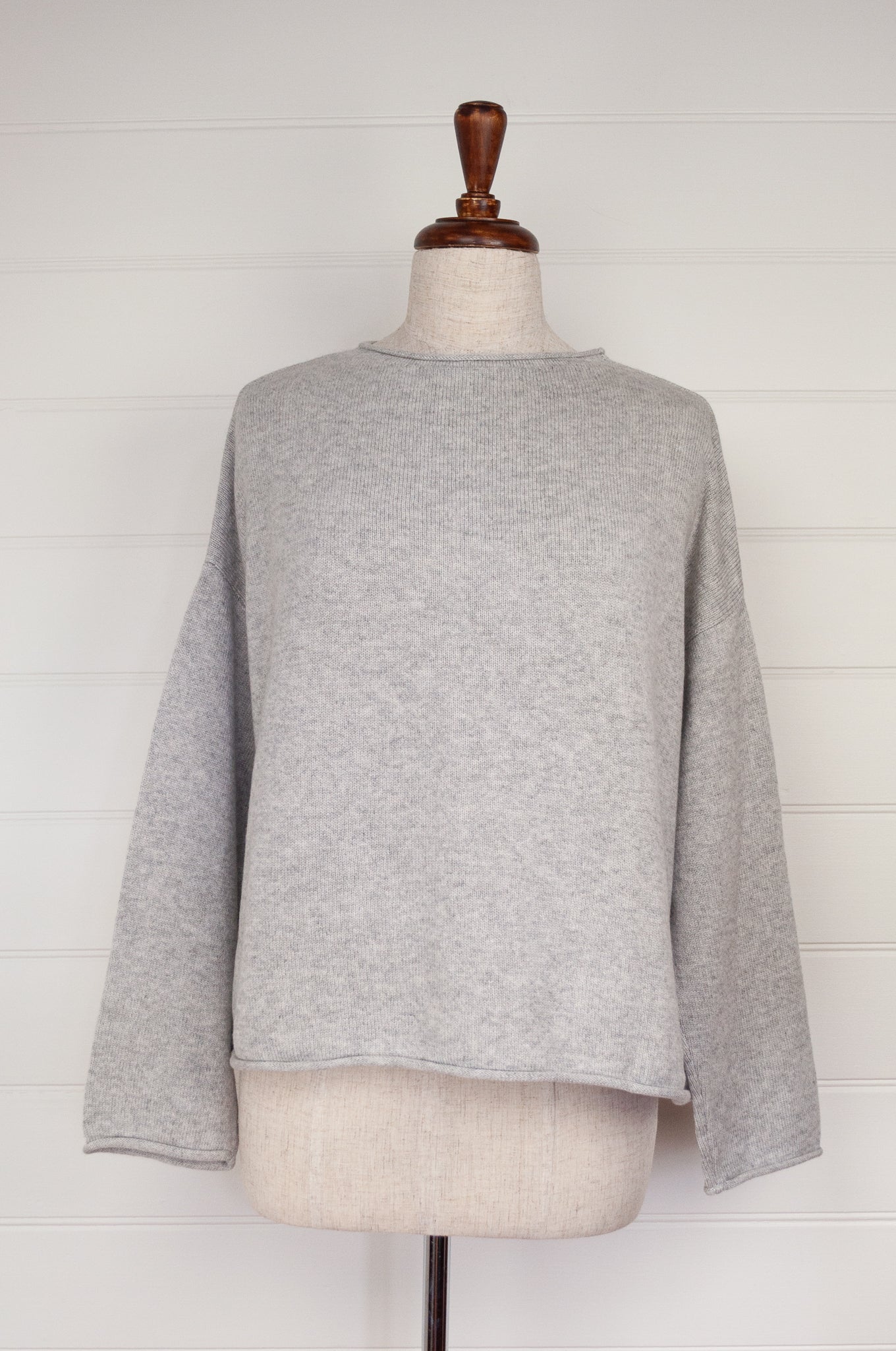 Juniper Hearth ash grey marle reversible one size cashmere cardigan, roll neck edges to neck, sleeves and hem, shell buttons, can be worn as a cardigan or reversed as a sweater.