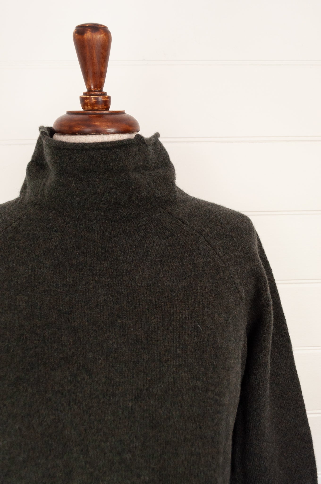 Eribe made in Scotland pure lambswool merino wool Corry raglan sweater, relaxed fit, roll neck, in Seaweed, deep olive green.