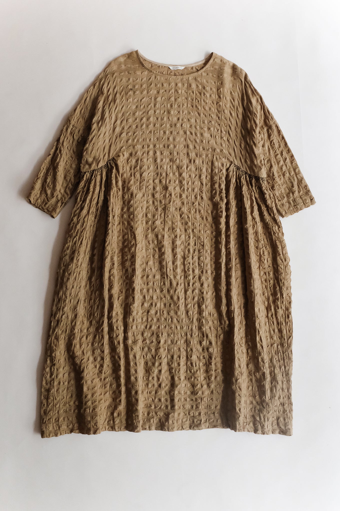 Runaway Bicycle Nora dress in cotton silk seersucker, side gather loose fit in sand brown.
