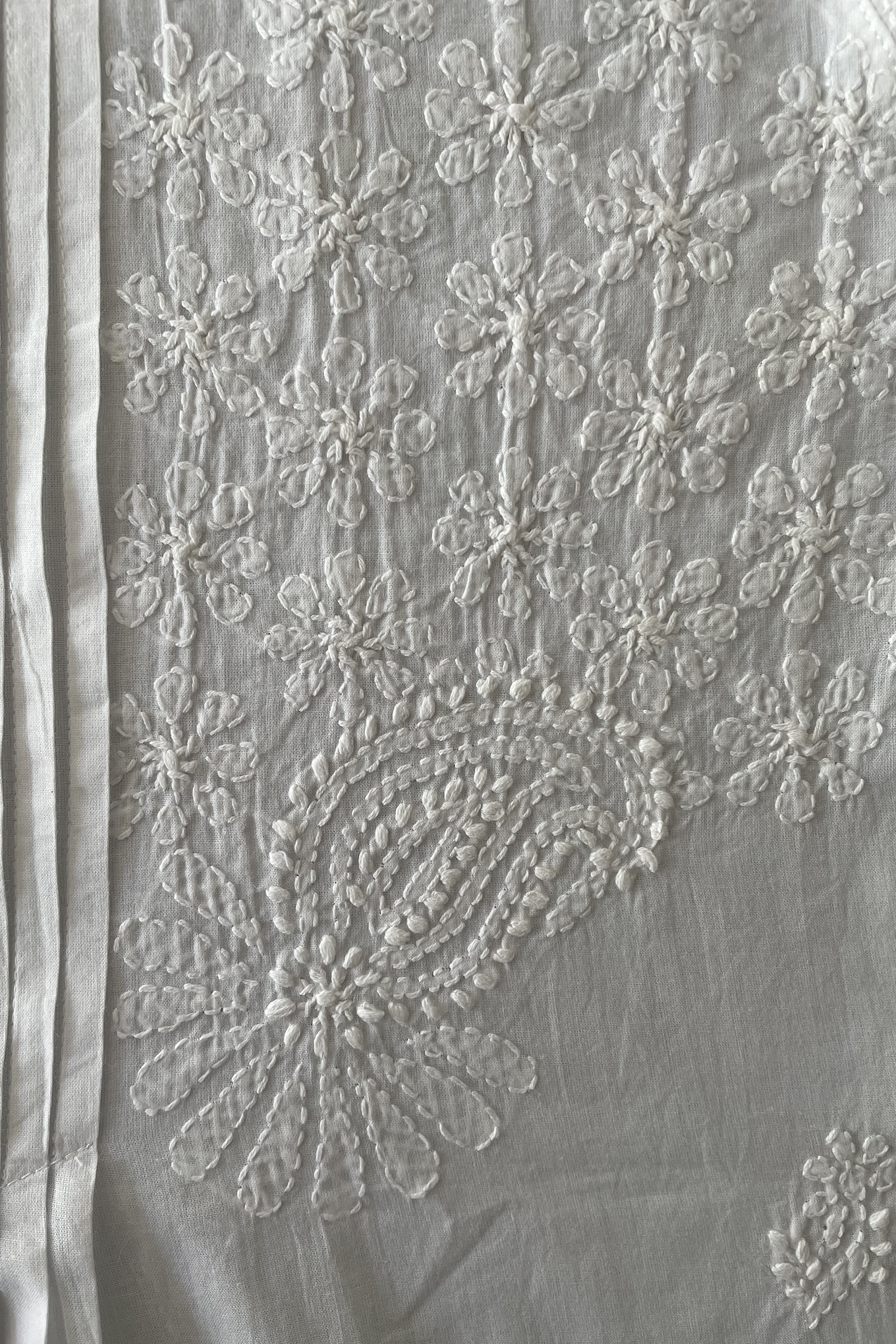 White on white chikankari embroidered pintucked blouse.