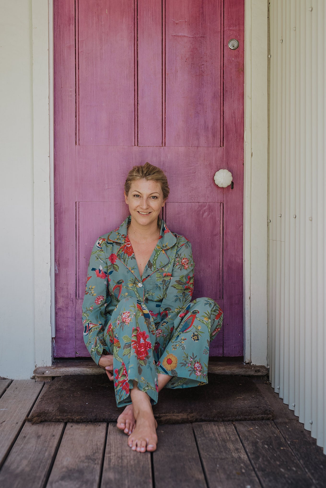 Juniper Hearth cotton voile pyjamas, screen printed with vibrant floral print on aqua blue background.