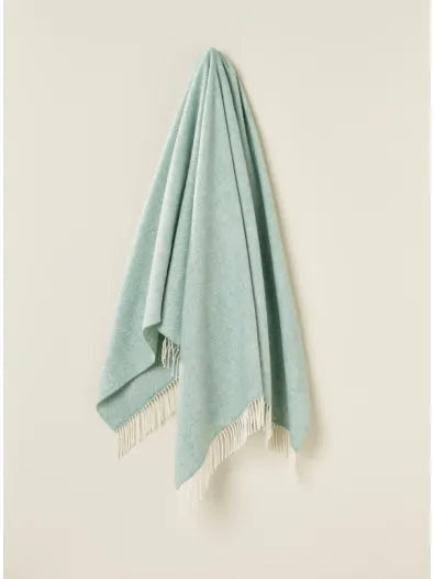 Bronte by Moon Herringbone throw in eucalyptus soft blue green merino wool. Made in England.