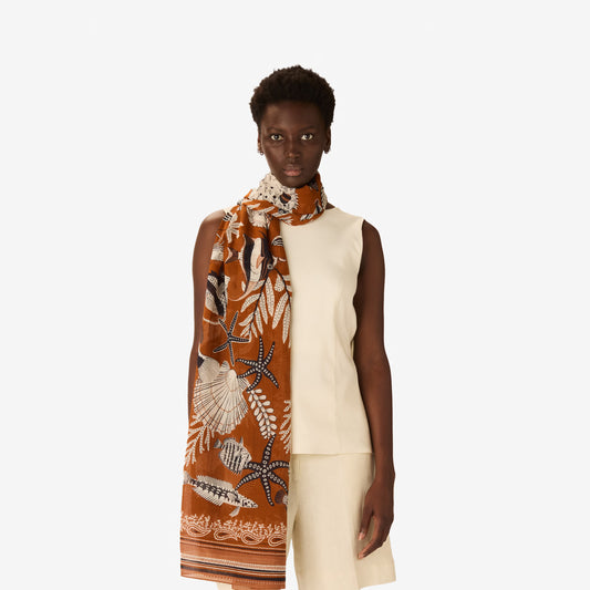 Inoui Editions Neptune Golden brown pure cotton scarf tan background with fish and underwater creatures.