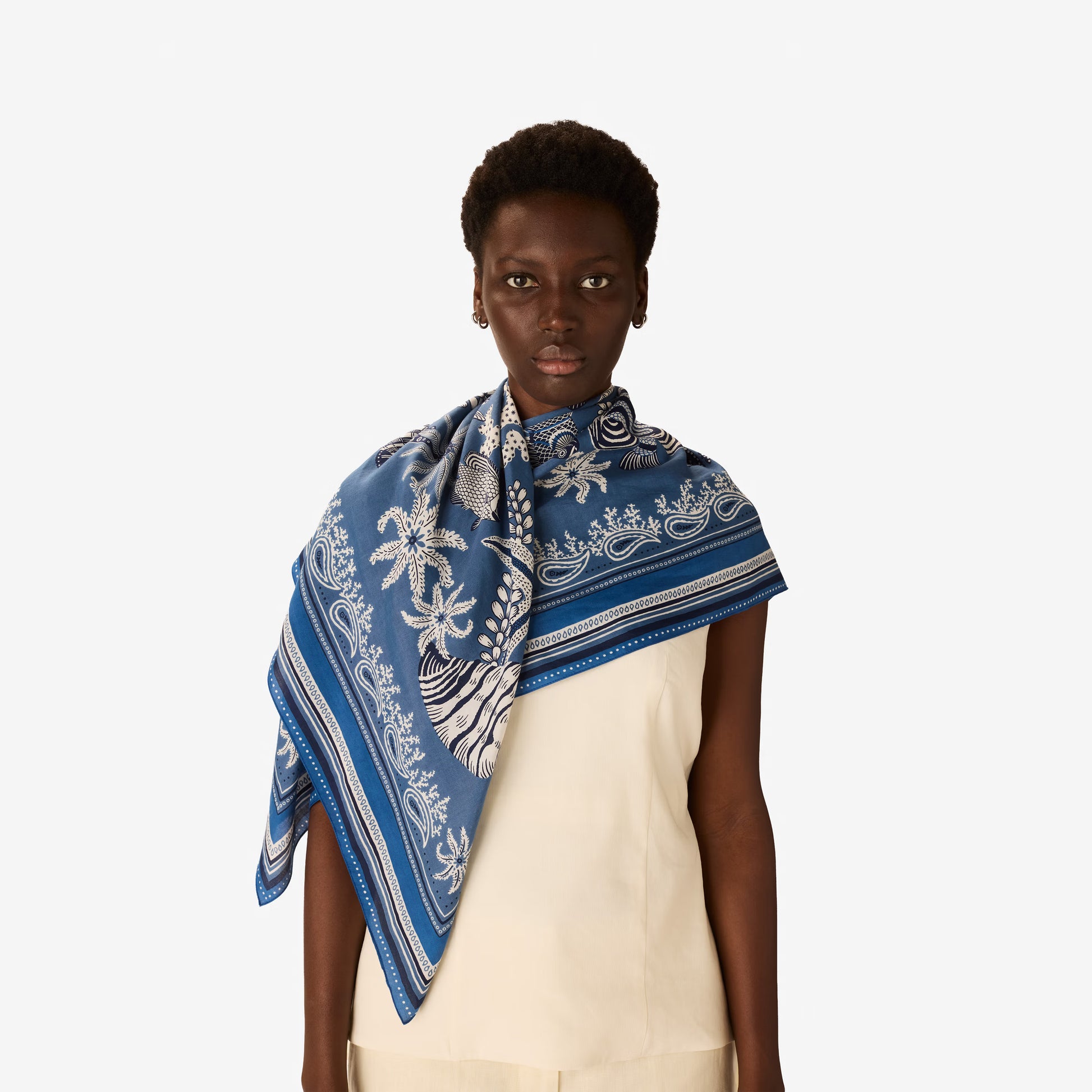 Inoui Editions Neptune pure silk carre, blue and white scarf with marine life design on a white background.