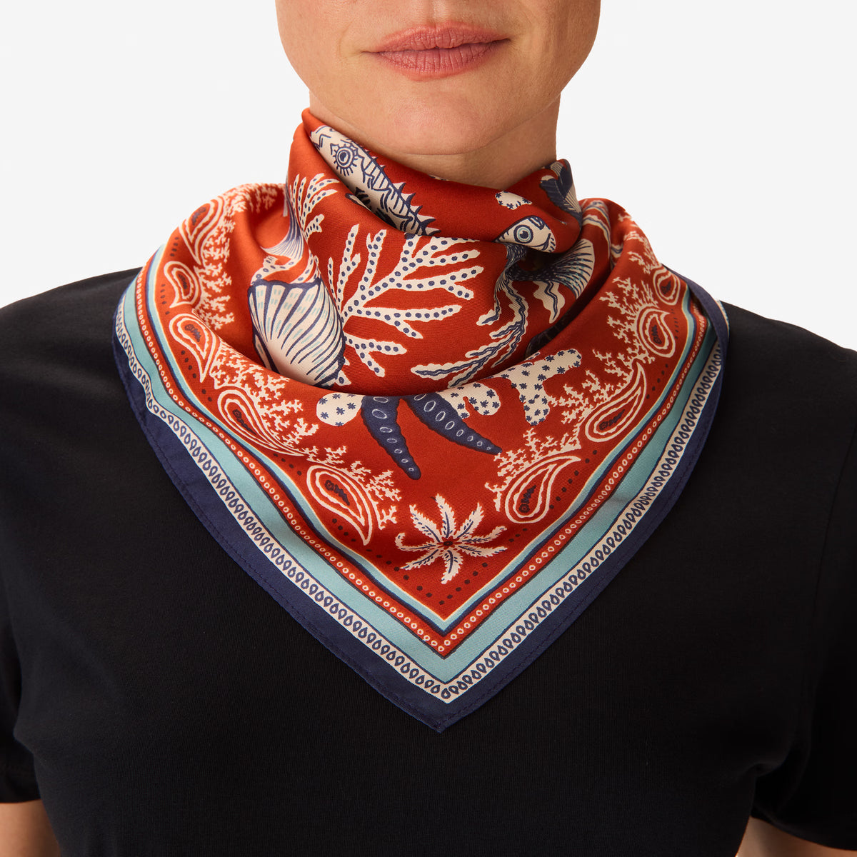 Inoui Editions Neptune pure silk carre, terracotta, blue and white scarf with marine life design on a white background.