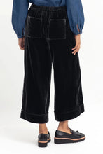 Load image into Gallery viewer, Elk Metti Velvet Pant in charcoal, wide leg with faux cuff, side and back pockets, elastic at the back of the waistband.