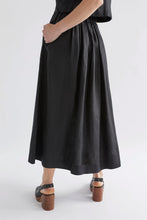 Load image into Gallery viewer, Elk the Label Elev pull on elastic waist midi length skirt in black linen.