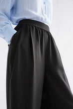 Load image into Gallery viewer, Elk Sepp pants in black, with elastic waist.