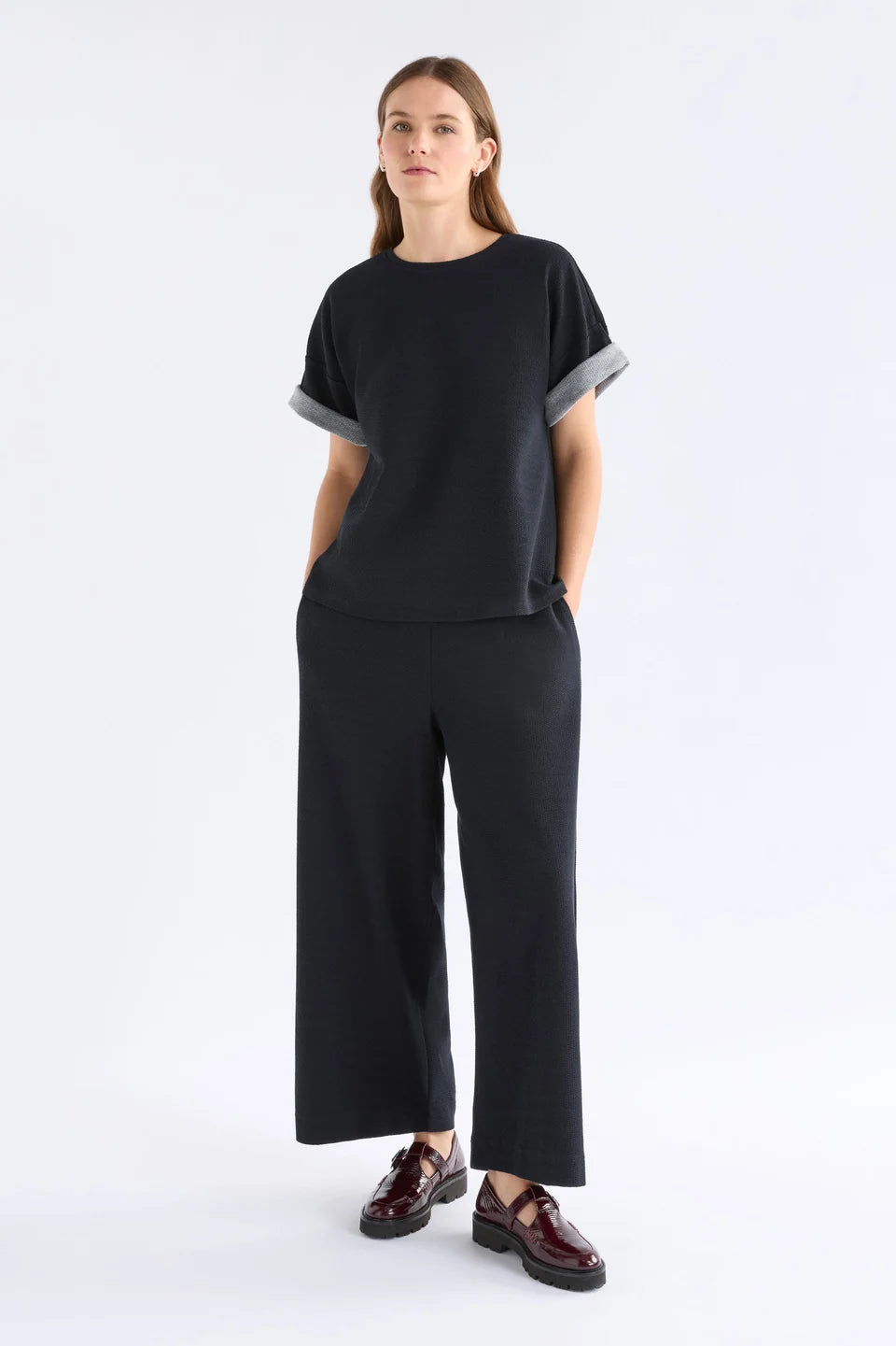 Elk Sanna pant, black wide-leg full length pants shown in textured organic cotton jersey.