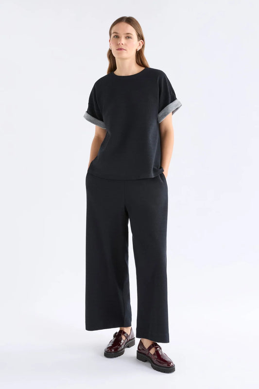Elk Sanna pant, black wide-leg full length pants shown in textured organic cotton jersey.
