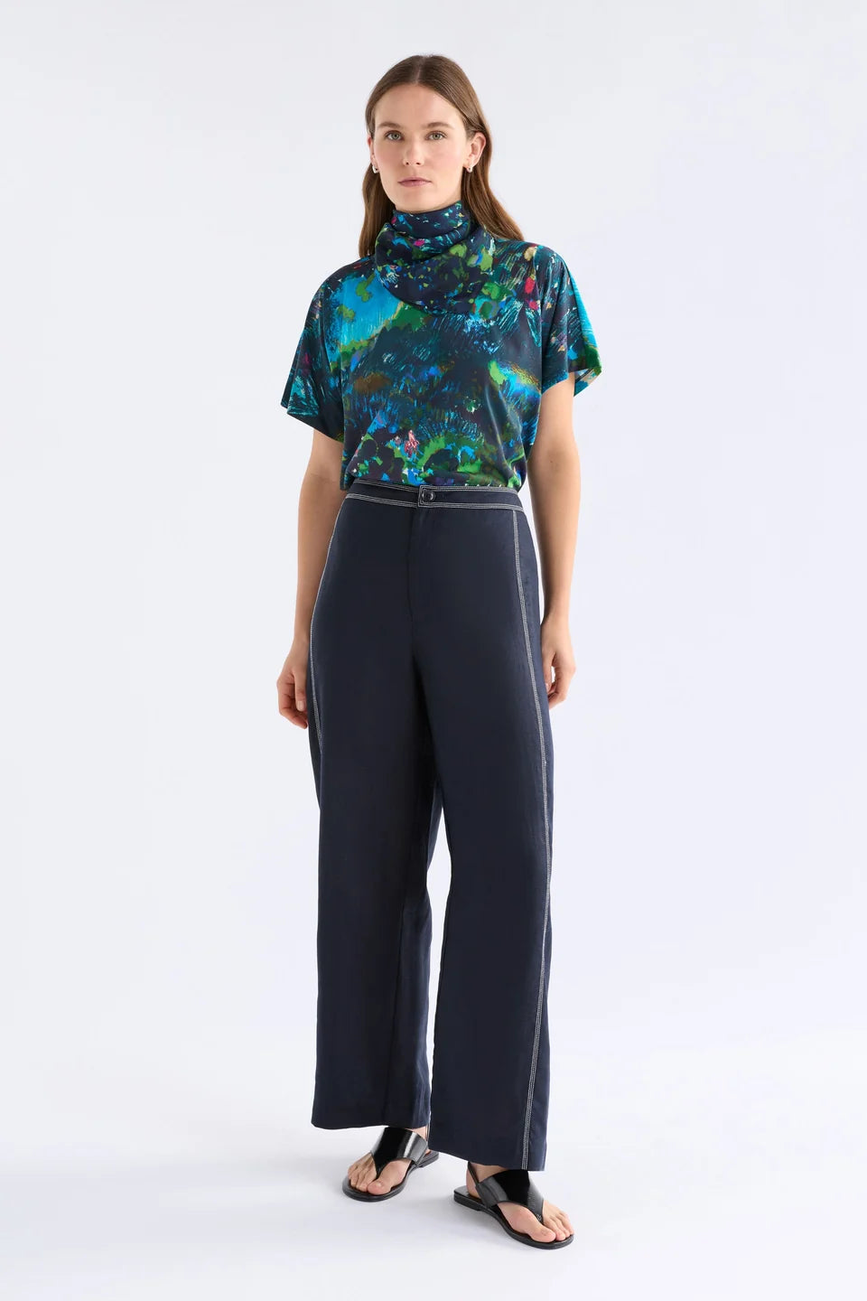Elk Landskap silk square scarf with an abstract, painterly pattern in shades of teal, green, black, and bright pink accents.