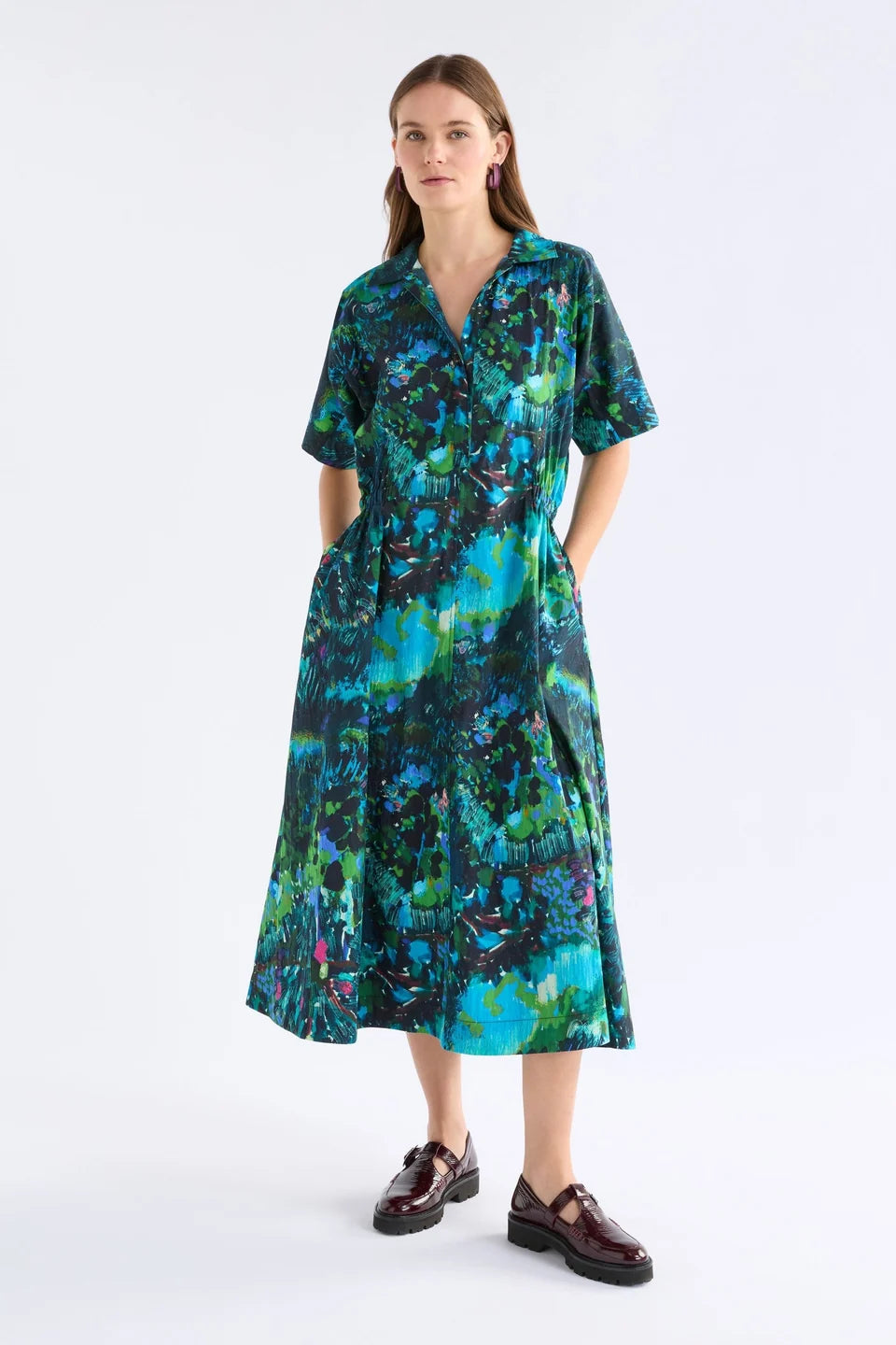Elk Bohn shirt dress short-sleeve collared with a vibrant abstract floral print in shades of teal, green, blue, and black.
