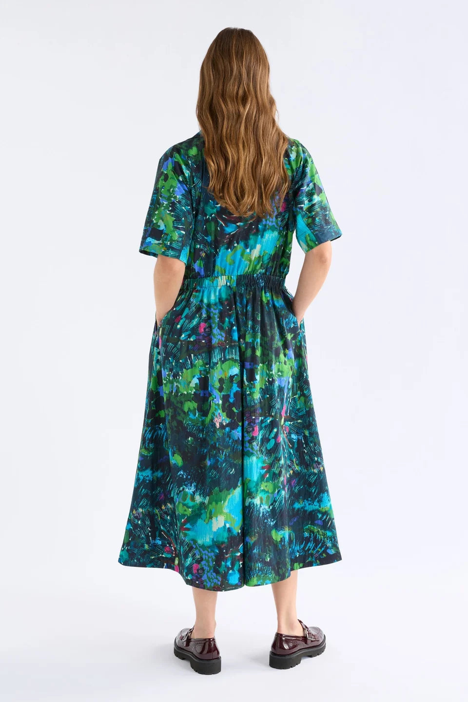 Elk Bohn shirt dress short-sleeve collared with a vibrant abstract floral print in shades of teal, green, blue, and black.