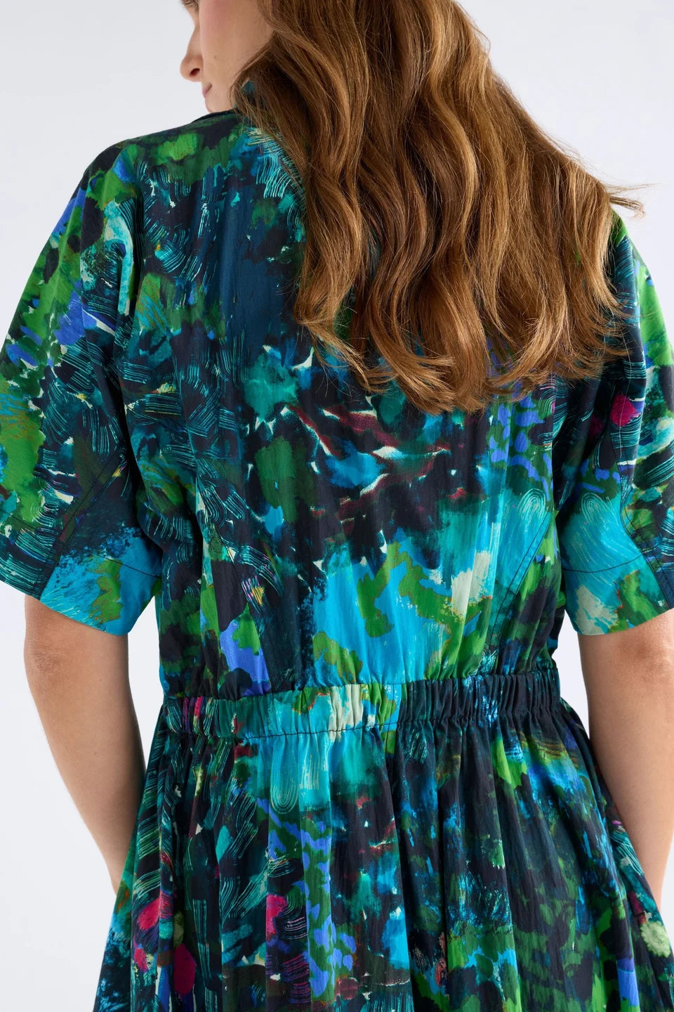 Elk Bohn shirt dress short-sleeve collared with a vibrant abstract floral print in shades of teal, green, blue, and black.