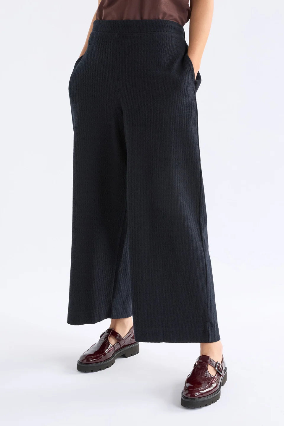 Elk Sanna pant, black wide-leg full length pants shown in textured organic cotton jersey.