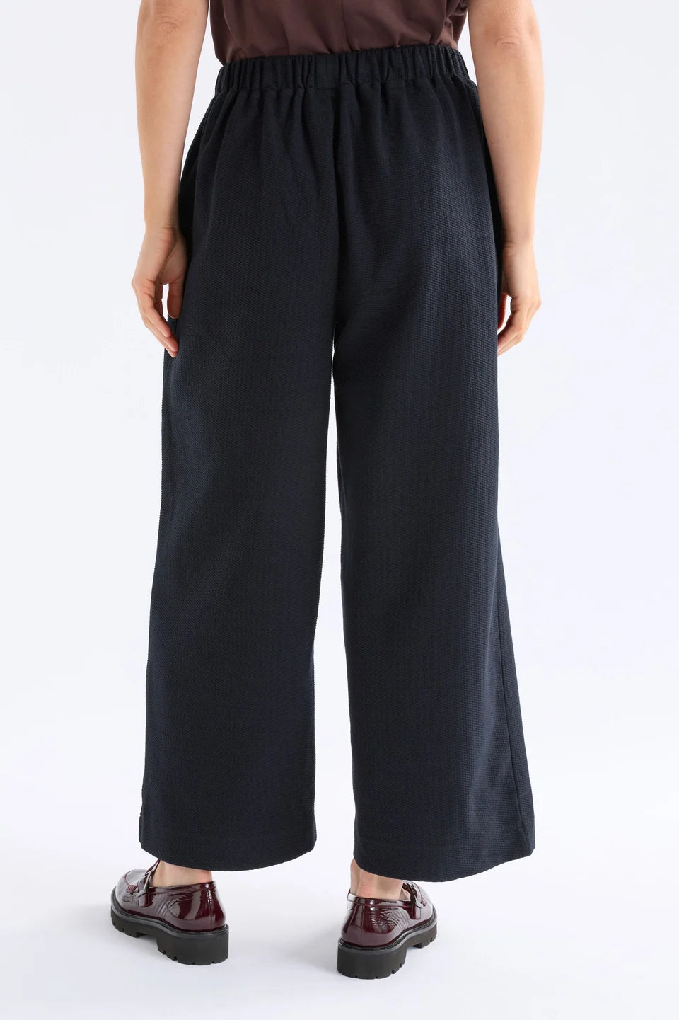 Elk Sanna pant, black wide-leg full length pants shown in textured organic cotton jersey.