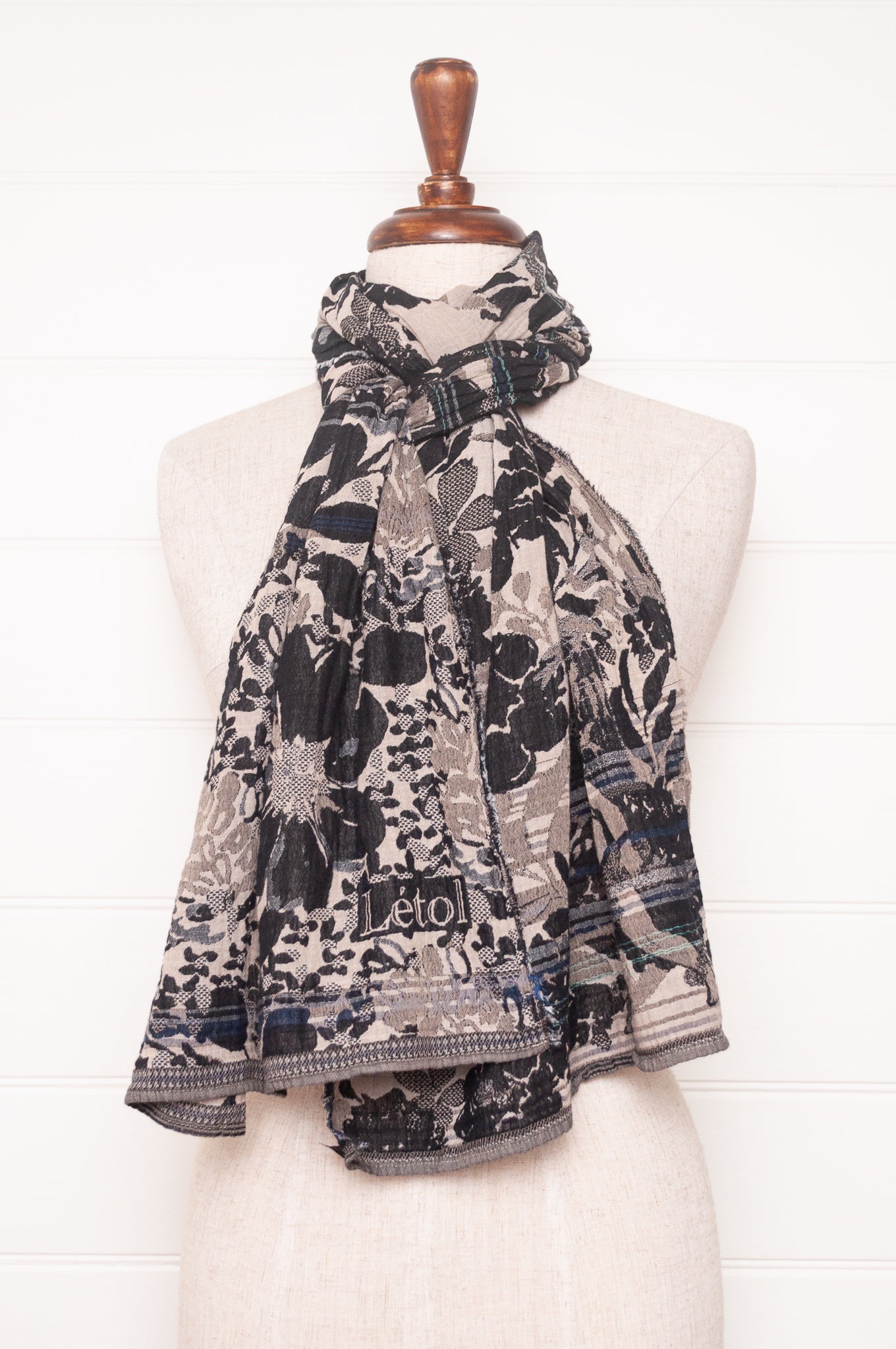 Letol organic cotton floral jacquard scarf Emilienne floral design in black, with highlights of blue.