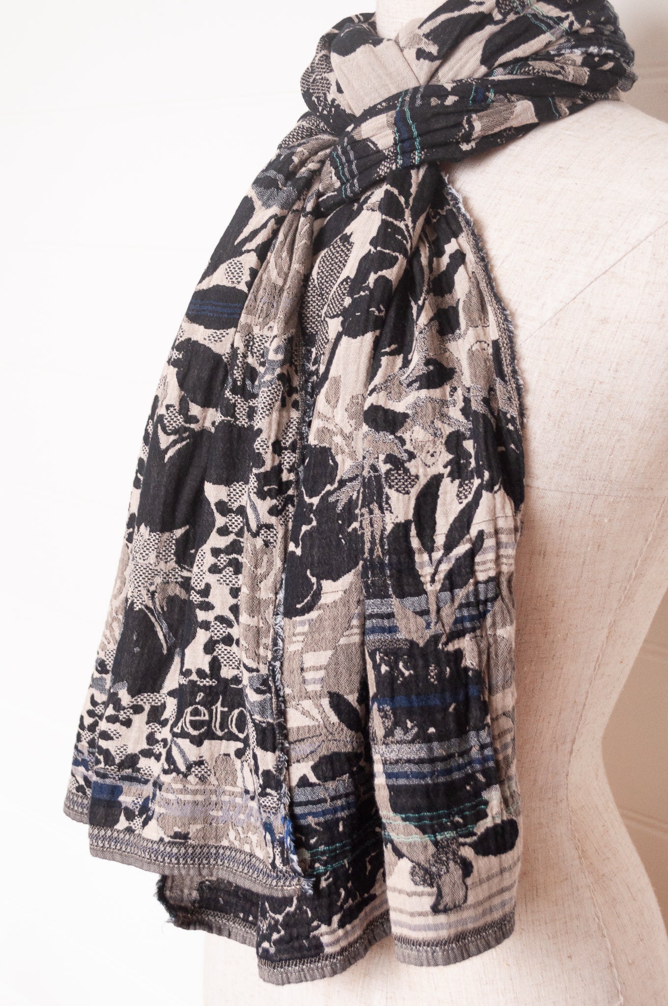 Letol organic cotton floral jacquard scarf Emilienne floral design in black, with highlights of blue.