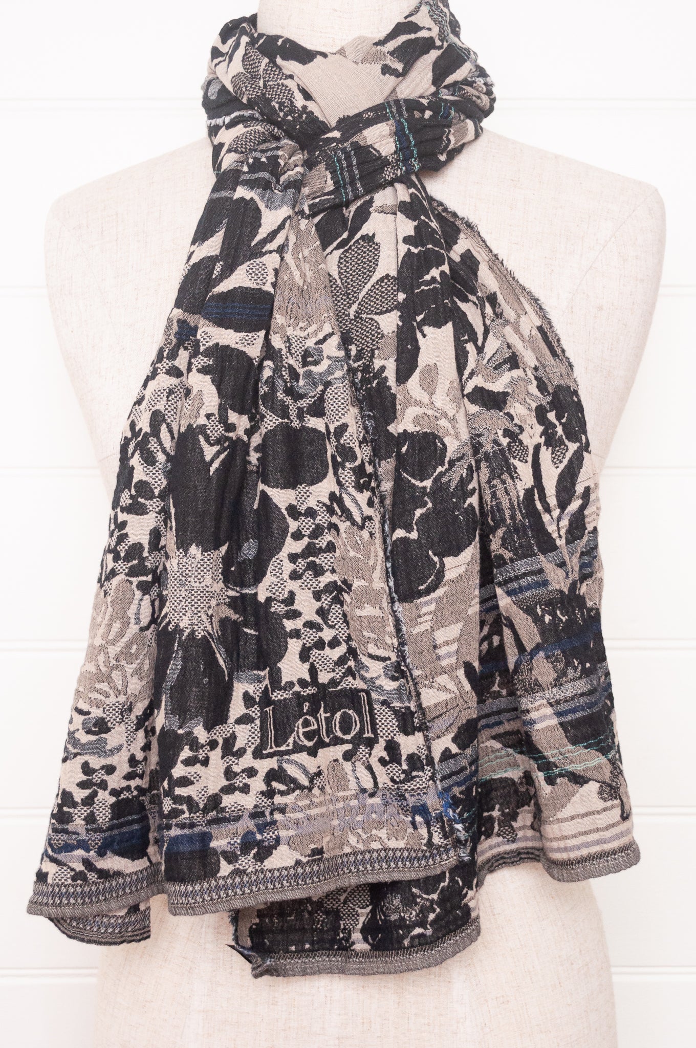 Letol organic cotton floral jacquard scarf Emilienne floral design in black, with highlights of blue.