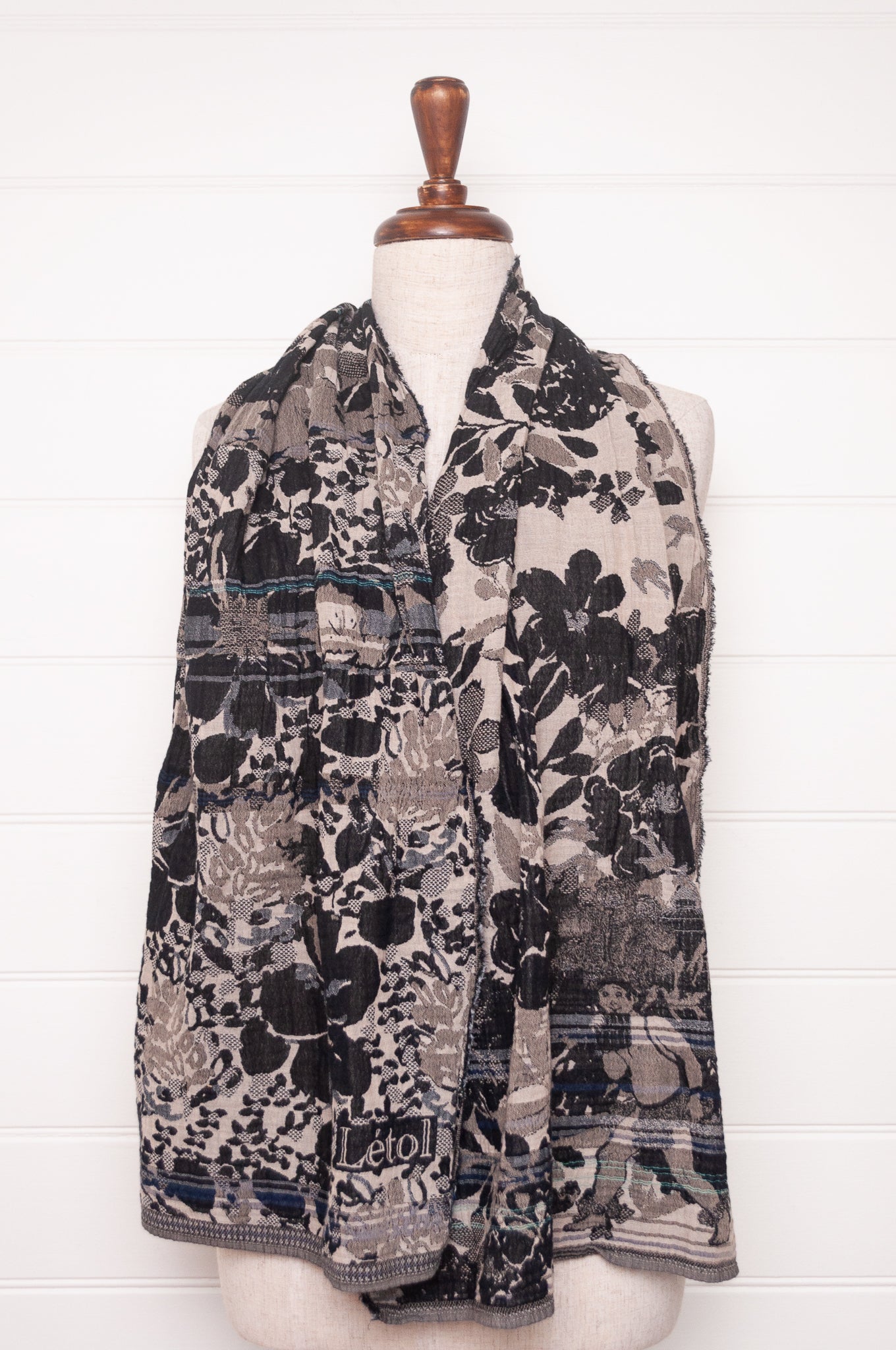 Letol organic cotton floral jacquard scarf Emilienne floral design in black, with highlights of blue.