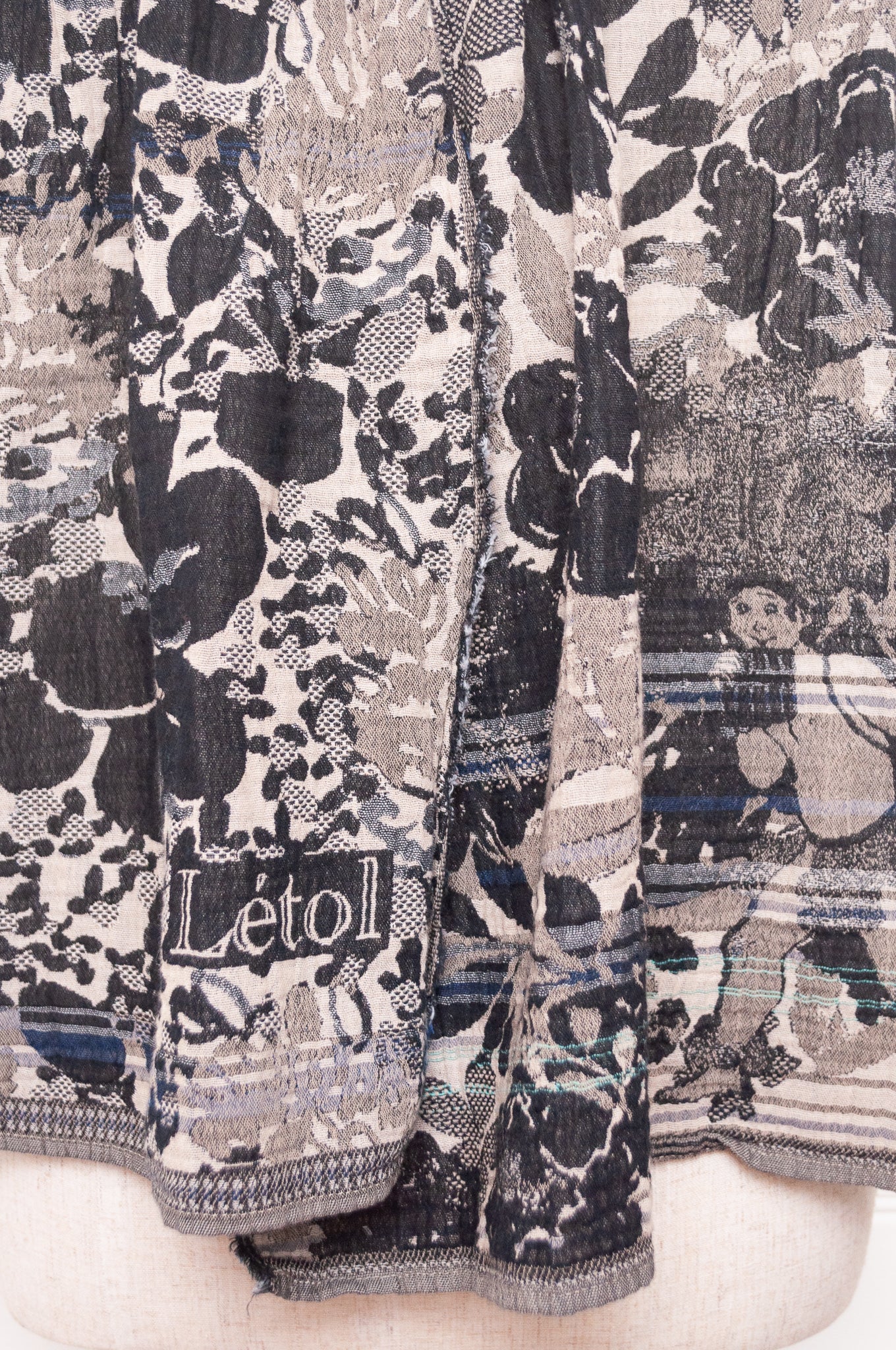Letol organic cotton floral jacquard scarf Emilienne floral design in black, with highlights of blue.