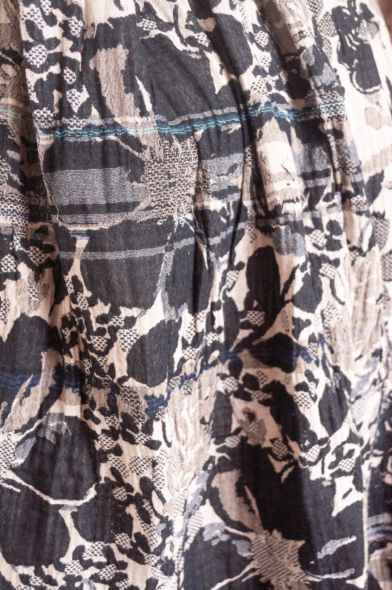 Letol organic cotton floral jacquard scarf Emilienne floral design in black, with highlights of blue.