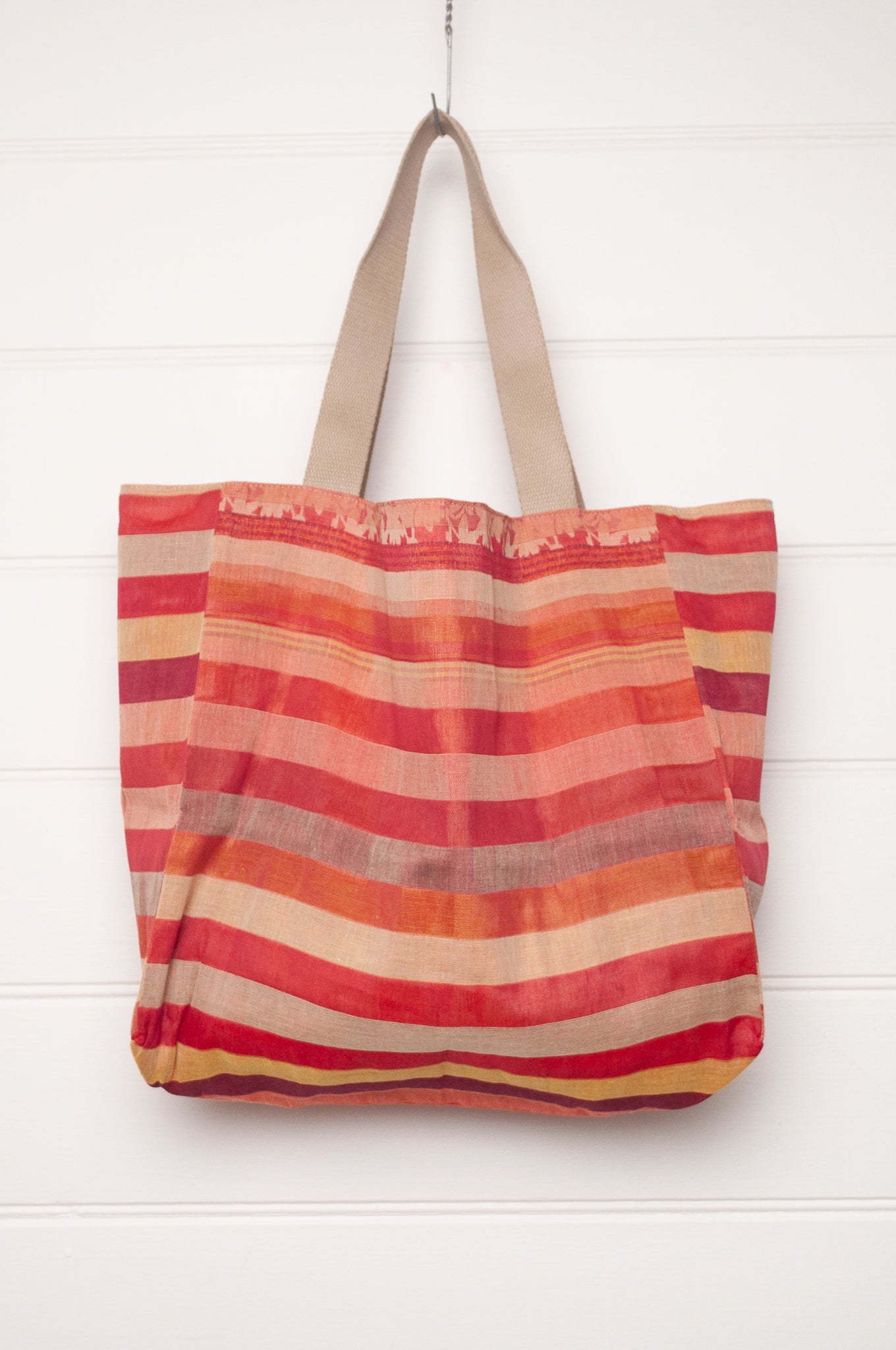Letol organic cotton jacquard weave tote bag in stripes in pink, orange and red, and floral design.