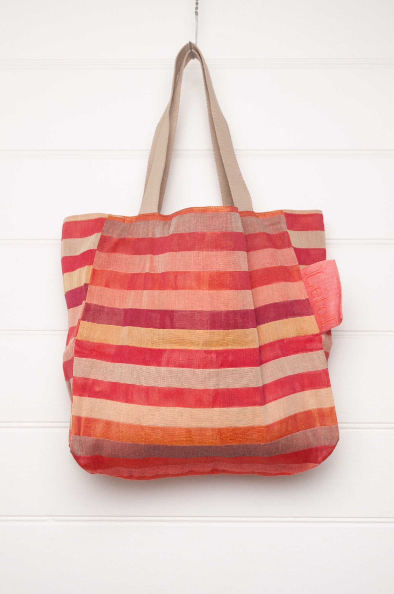 Letol organic cotton jacquard weave tote bag in stripes in pink, orange and red, and floral design.