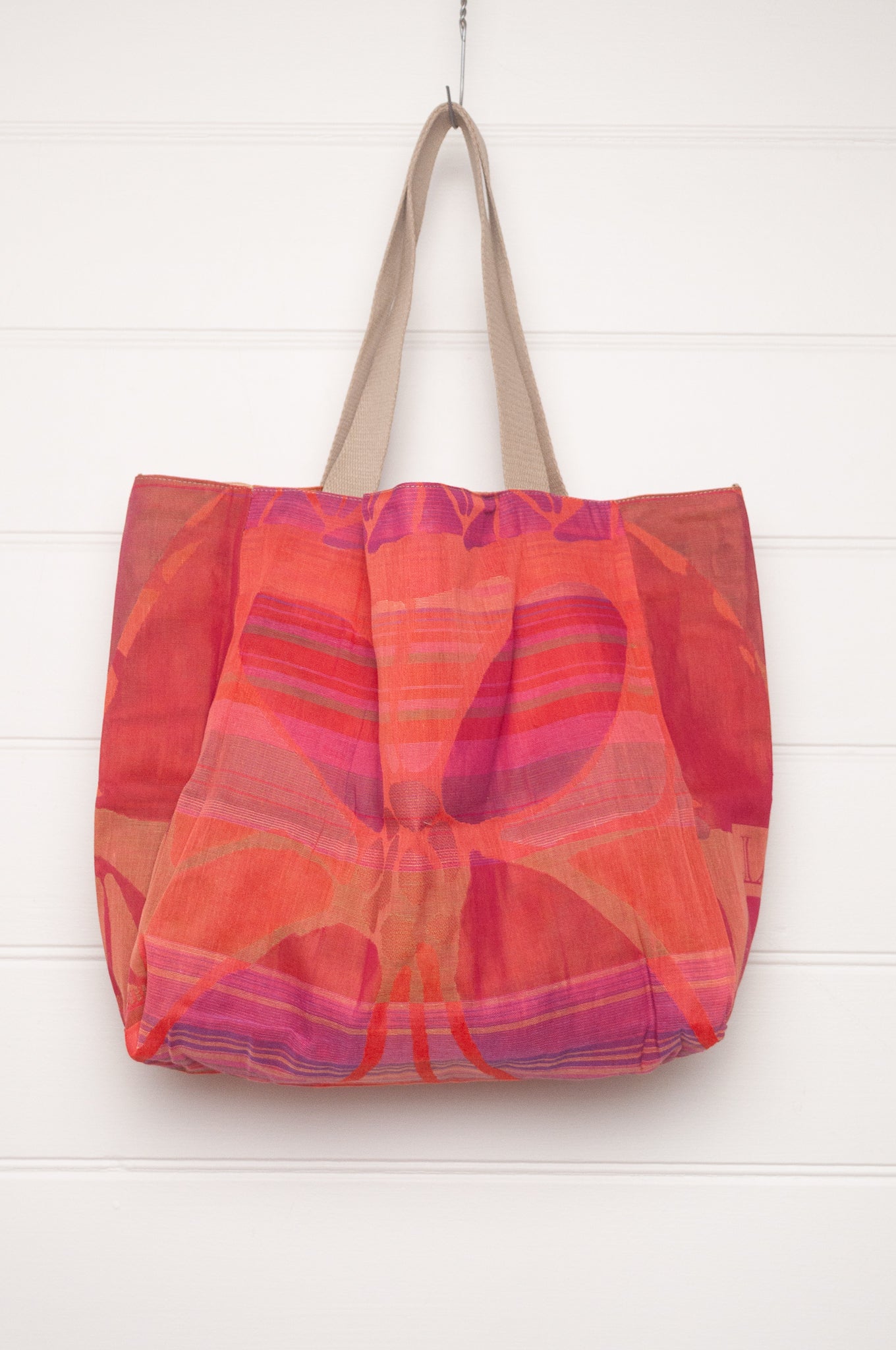 Letol organic cotton jacquard weave tote bag in stripes in pink, orange and red, and floral design.