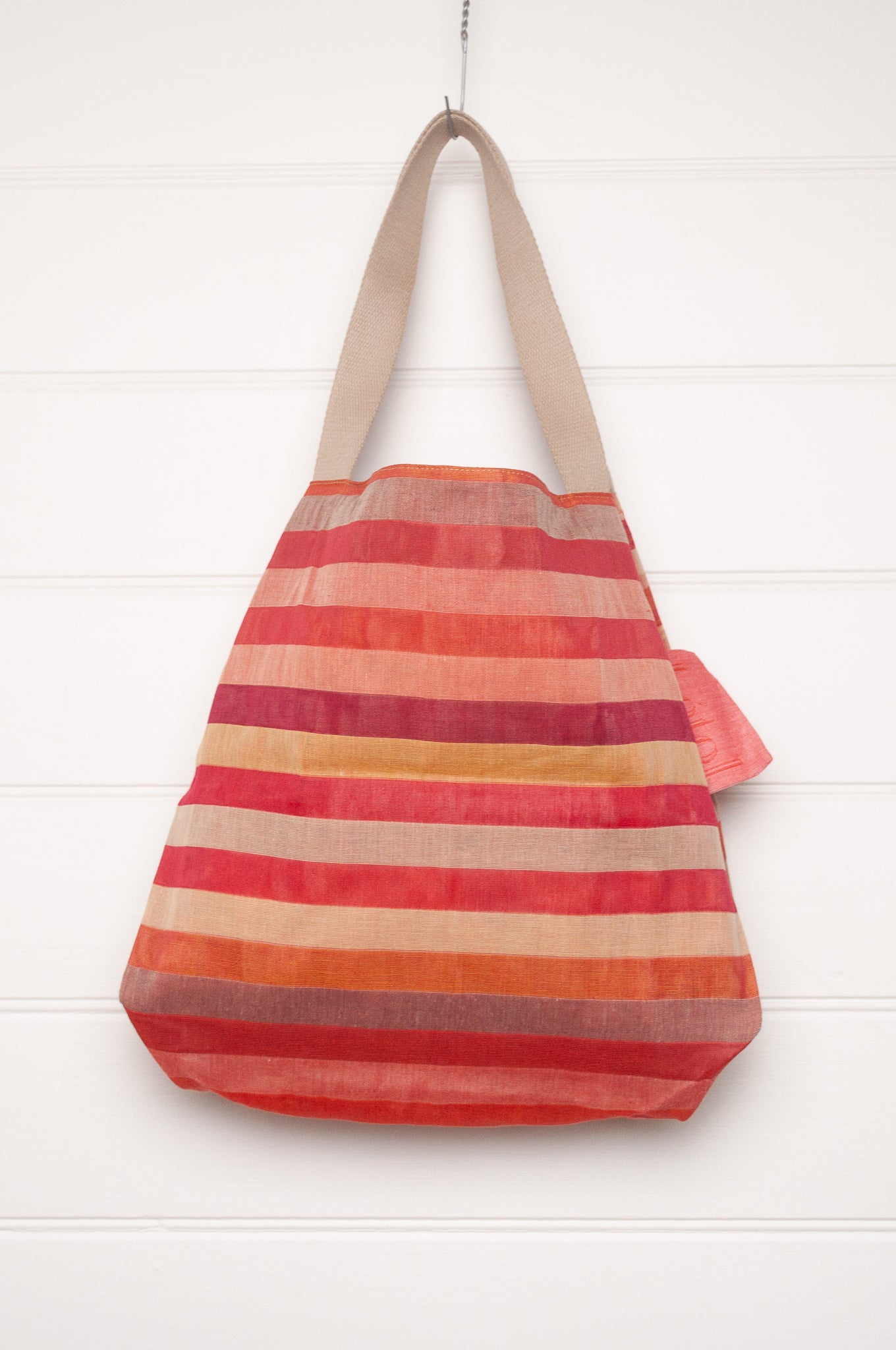 Letol organic cotton jacquard weave tote bag in stripes in pink, orange and red, and floral design.