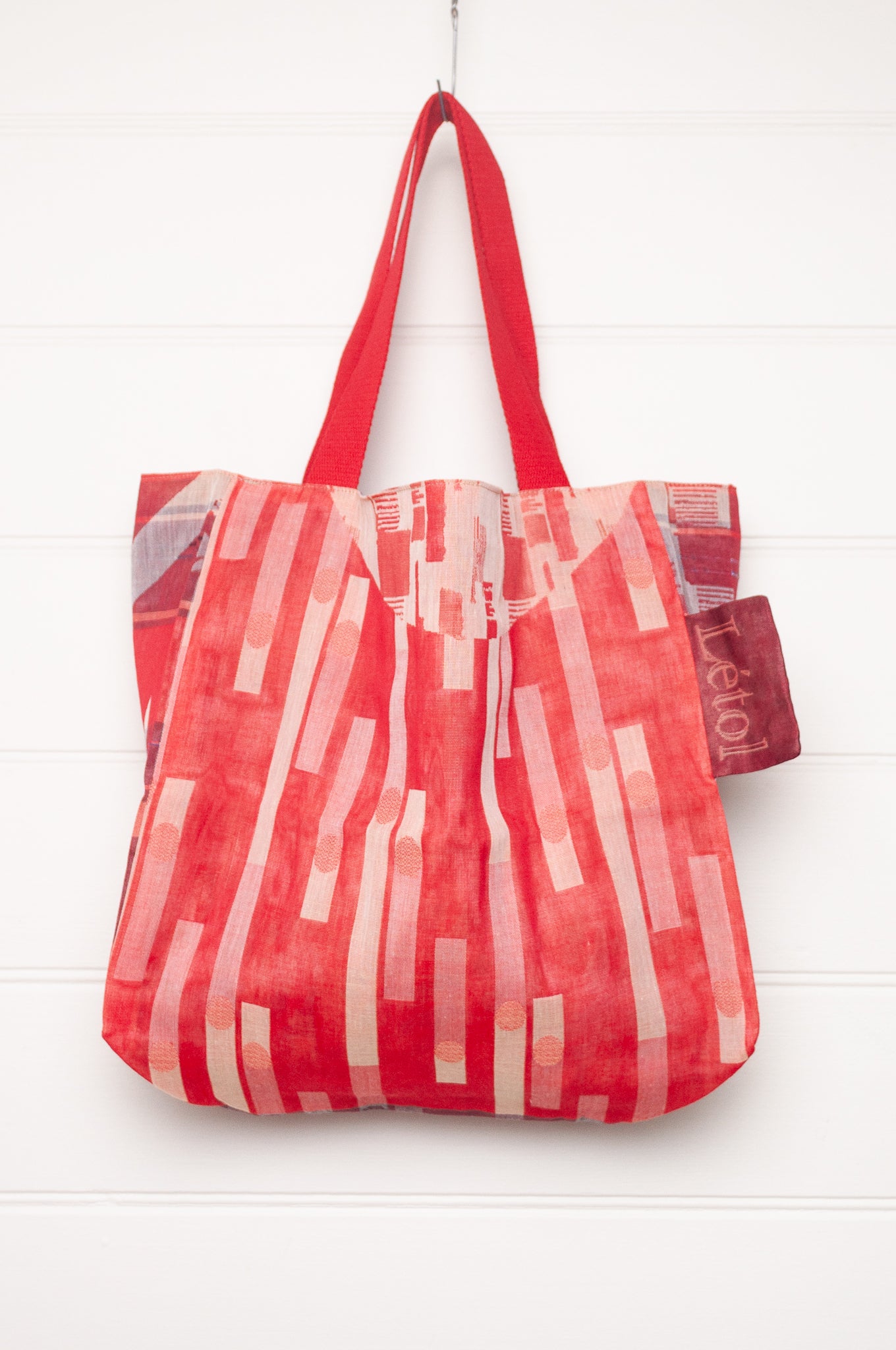 Letol organic cotton jacquard weave tote bag in foliage and stripes in red and pink.