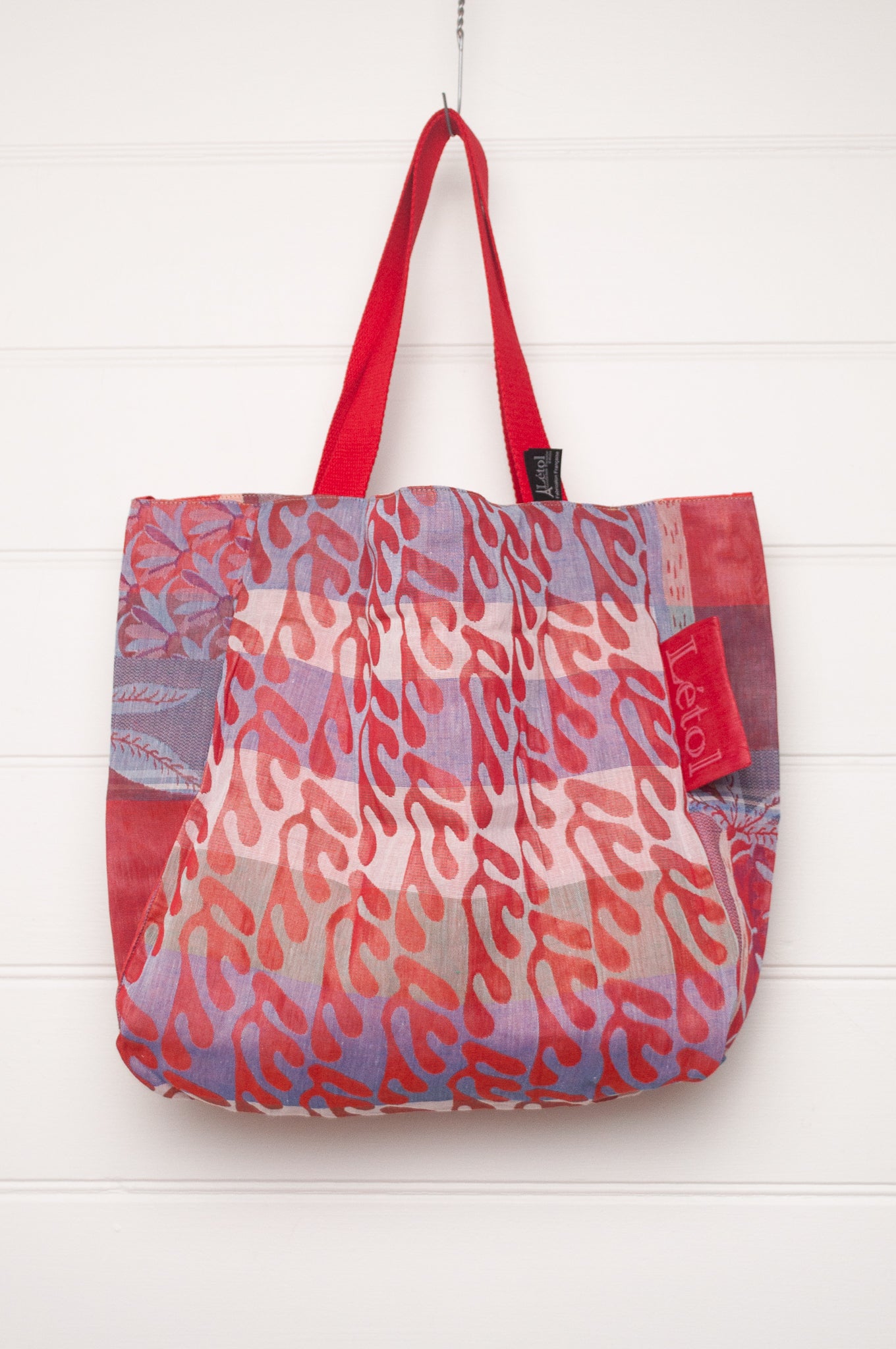 Letol organic cotton jacquard weave tote bag in foliage and stripes in red and pink.